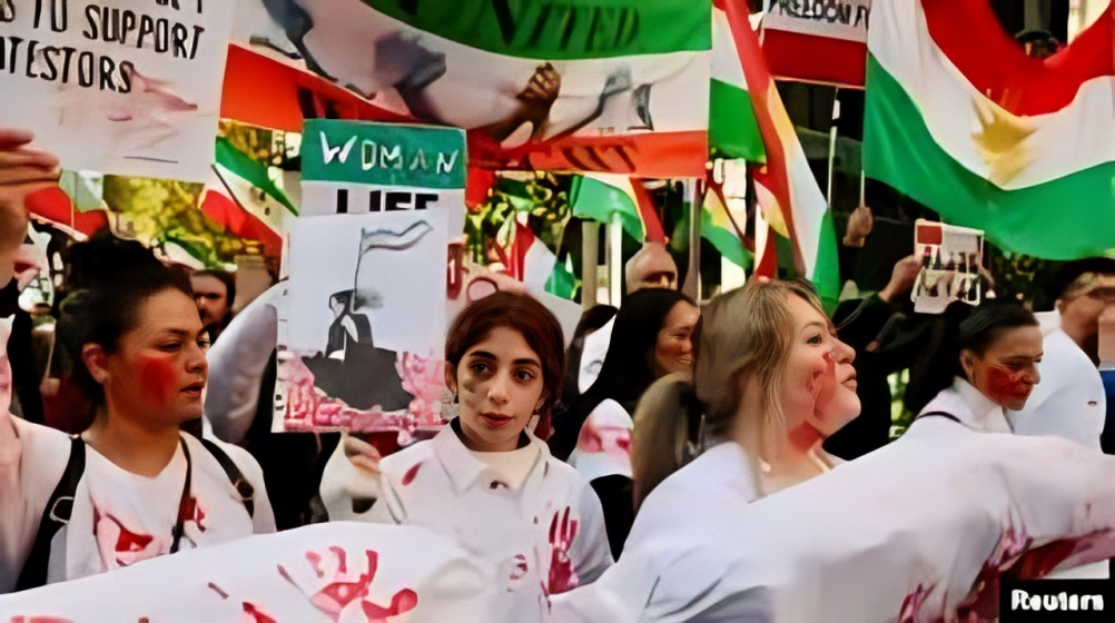 Crowd of protesters in central Tehran waving Iranian flags and banners