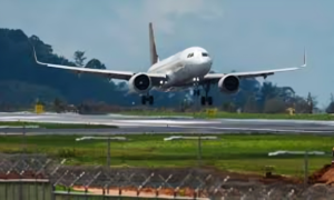 Aircraft making a mid-air turn with runway in background