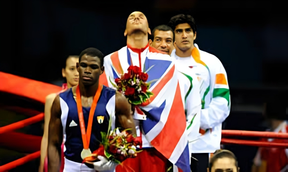Three Olympic medalists standing on the podium, draped in their country’s flags