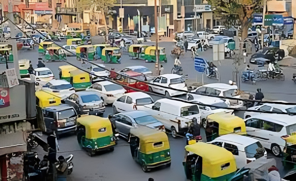 Delhi skyline with mixed-age vehicles on road